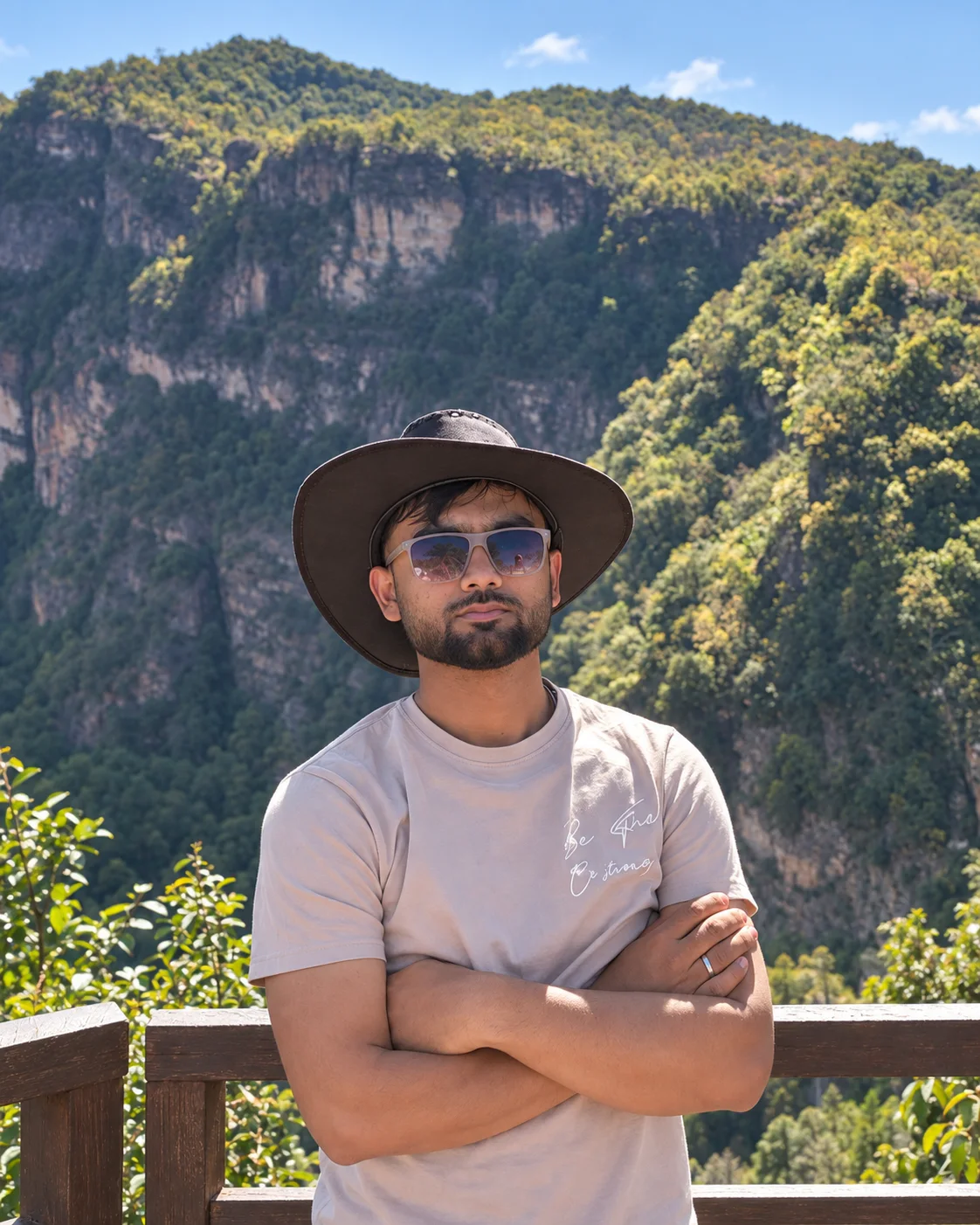 Anas standing before a mountain landscape